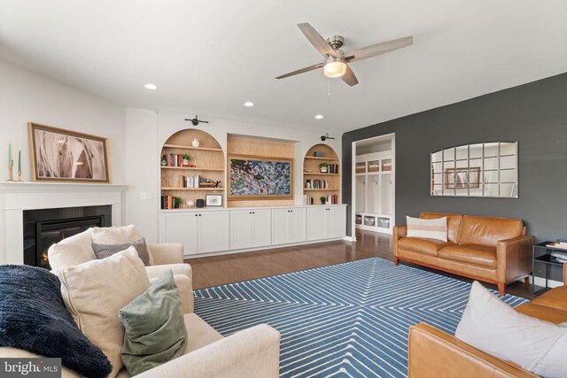 10430 Aspen Highlands Dr, Spotsylvania, VA 22553 - living area with ceiling fan, dark wood-style floors, a glass covered fireplace, recessed lighting, and built in features