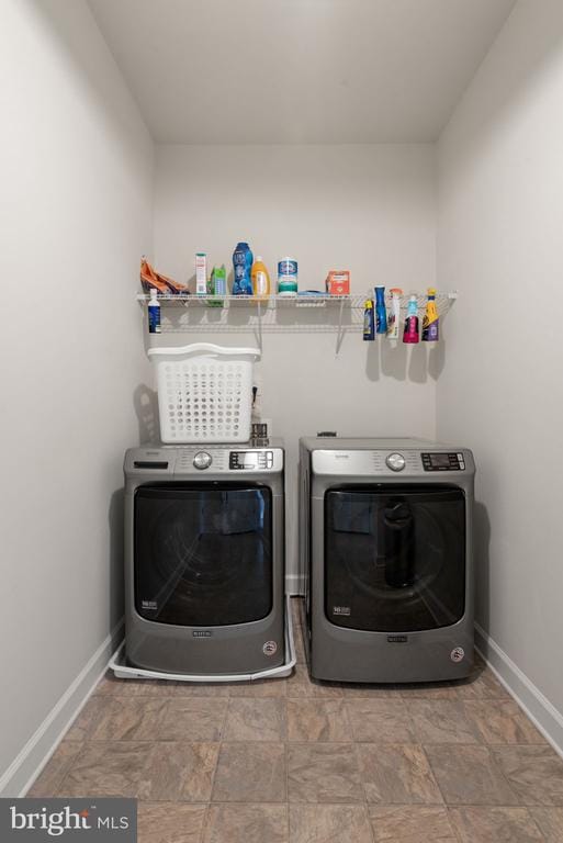 10430 Aspen Highlands Dr, Spotsylvania, VA 22553 - laundry room with washing machine and clothes dryer, baseboards, and stone finish flooring