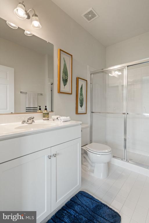 10430 Aspen Highlands Dr, Spotsylvania, VA 22553 - bathroom with a stall shower, tile patterned floors, toilet, and vanity