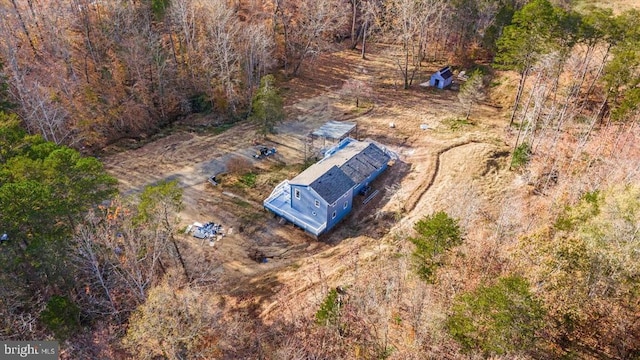 view of subject property with a heavily wooded area