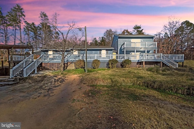 rear view of property with stairway and a wooden deck