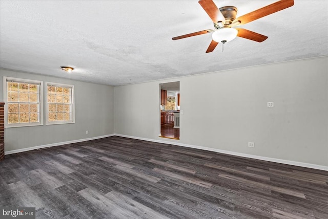 empty room with wood finished floors, a textured ceiling, a ceiling fan, and baseboards