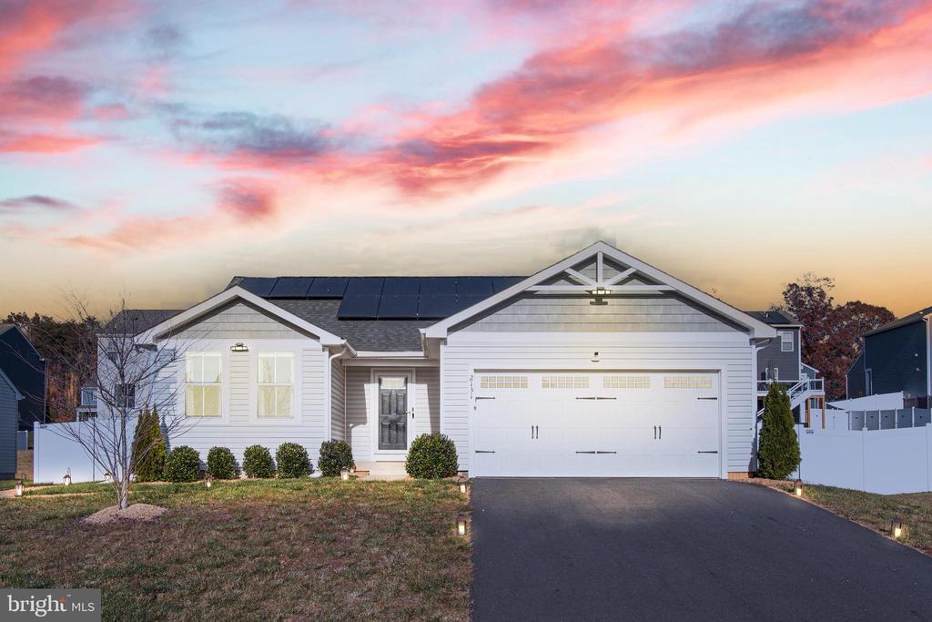 view of front of house with a garage and solar panels