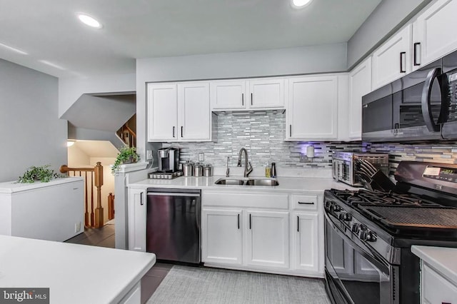 11222 Gander Ct, Fredericksburg, VA 22407 - kitchen with black appliances, light countertops, backsplash, white cabinetry, and recessed lighting