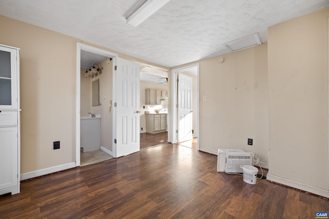 228 Old Fifteen Rd, New Canton, VA 23123 - unfurnished bedroom featuring wood finished floors, a textured ceiling, attic access, connected bathroom, and baseboards
