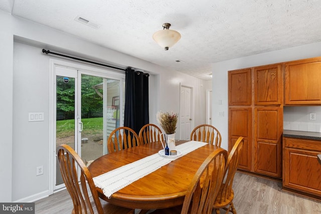 6701 Towles Mill Rd, Spotsylvania, VA 22551 - dining space with light wood finished floors and a textured ceiling