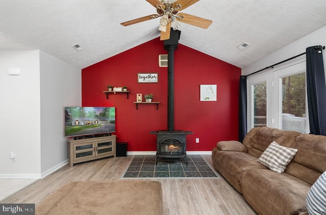 6701 Towles Mill Rd, Spotsylvania, VA 22551 - living area featuring lofted ceiling, a wood stove, wood finished floors, ceiling fan, and baseboards
