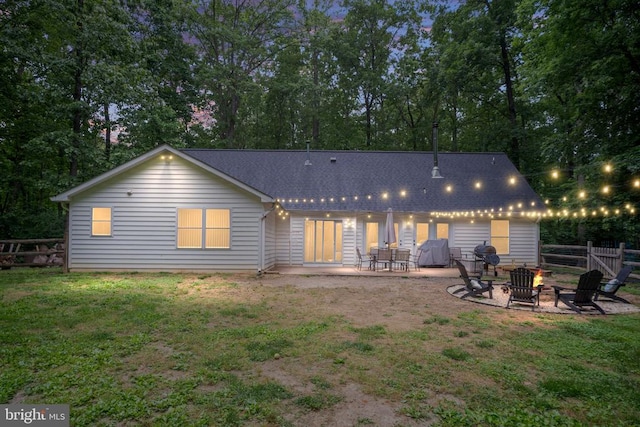 6701 Towles Mill Rd, Spotsylvania, VA 22551 - back of house with an outdoor fire pit, a patio, roof with shingles, and view of scattered trees