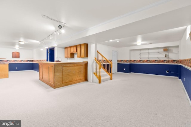 10911 Jarvis Ct, Fredericksburg, VA 22407 - kitchen with light colored carpet, a peninsula, track lighting, open floor plan, and ornamental molding