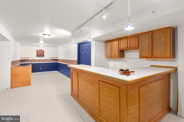 10911 Jarvis Ct, Fredericksburg, VA 22407 - kitchen featuring light carpet, track lighting, hanging light fixtures, brown cabinets, and a peninsula
