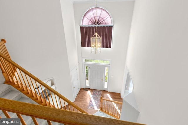 10911 Jarvis Ct, Fredericksburg, VA 22407 - entryway featuring a towering ceiling, stairway, wood finished floors, and a chandelier
