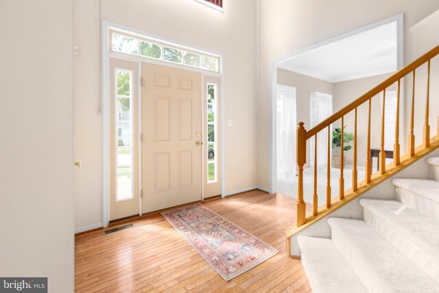10911 Jarvis Ct, Fredericksburg, VA 22407 - foyer entrance featuring hardwood / wood-style floors, stairs, ornamental molding, and a high ceiling