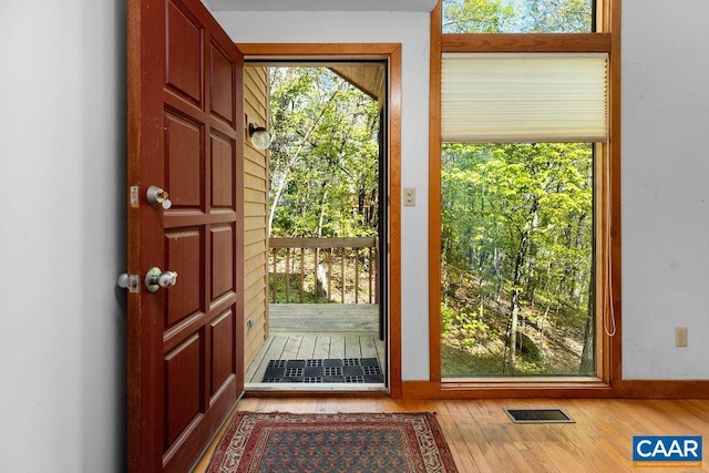 doorway featuring wood finished floors and baseboards