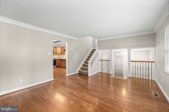 6908 Wild Turkey Dr, Spotsylvania, VA 22553 - empty room with ornate columns, wood finished floors, crown molding, and stairway