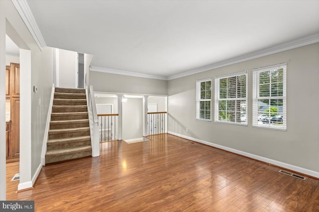 6908 Wild Turkey Dr, Spotsylvania, VA 22553 - empty room featuring light wood-style flooring, crown molding, stairway, and ornate columns