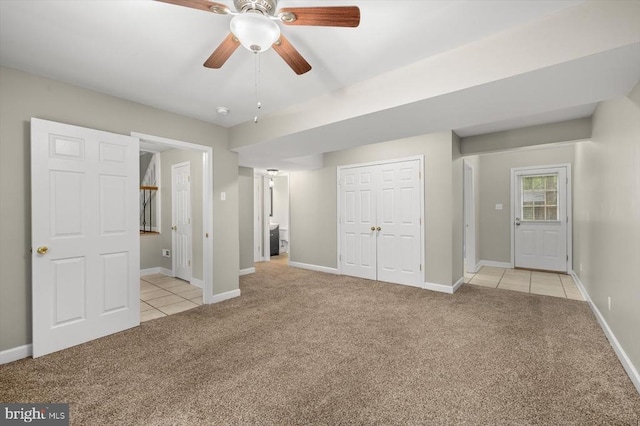 6908 Wild Turkey Dr, Spotsylvania, VA 22553 - unfurnished bedroom featuring light colored carpet, light tile patterned floors, a closet, and a ceiling fan
