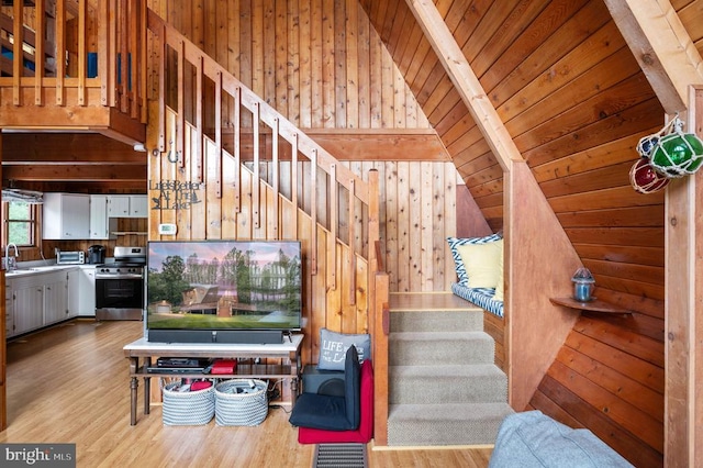 3477 Elk Creek Rd, Mineral, VA 23117 - living area with wood walls, wood finished floors, stairway, and vaulted ceiling