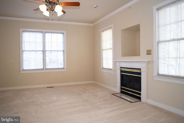 unfurnished living room featuring a ceiling fan, light colored carpet, a fireplace with flush hearth, ornamental molding, and baseboards