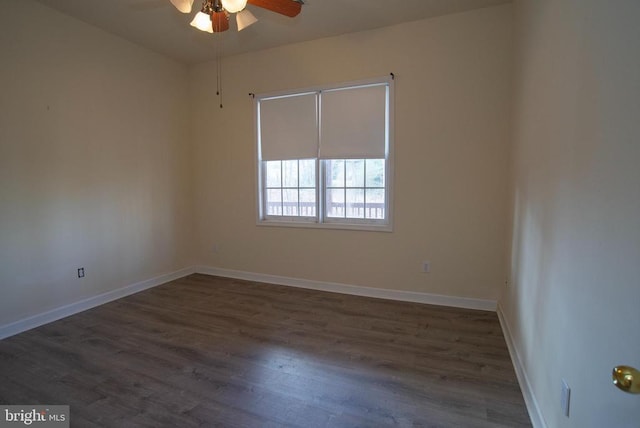 empty room with ceiling fan, wood finished floors, and baseboards