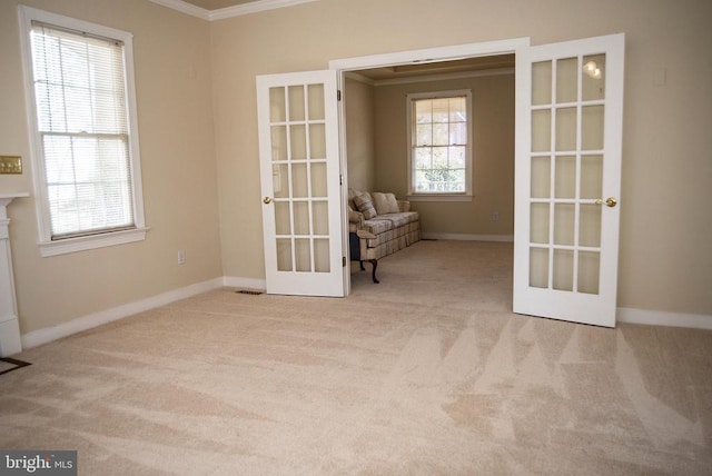 unfurnished room with french doors, ornamental molding, carpet, and baseboards