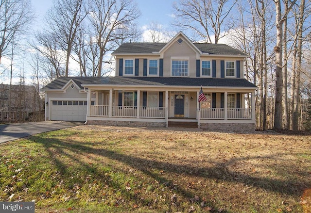 colonial inspired home featuring covered porch, concrete driveway, an attached garage, and a front yard