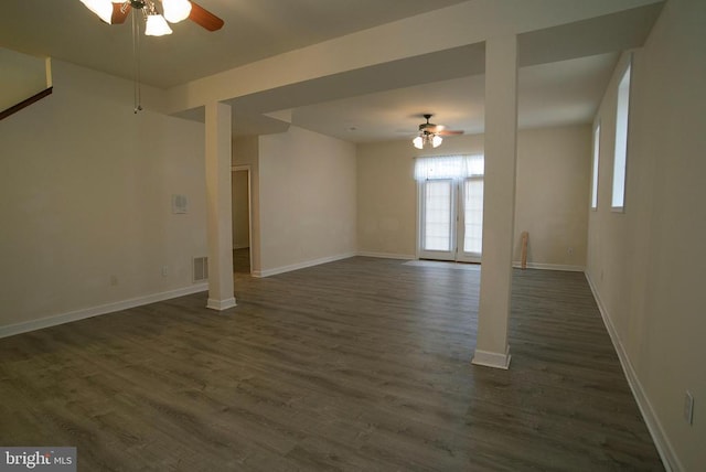 unfurnished living room with a ceiling fan, dark wood-type flooring, and baseboards