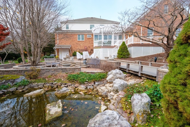 5 Trace Dr, Staunton, VA 24401 - back of house featuring stairs, a patio, a small pond, brick siding, and a pergola
