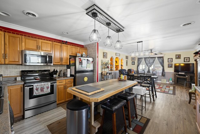 1751 New Hope And Crimora Rd, Crimora, VA 24431 - kitchen with visible vents, pendant lighting, crown molding, decorative backsplash, and appliances with stainless steel finishes