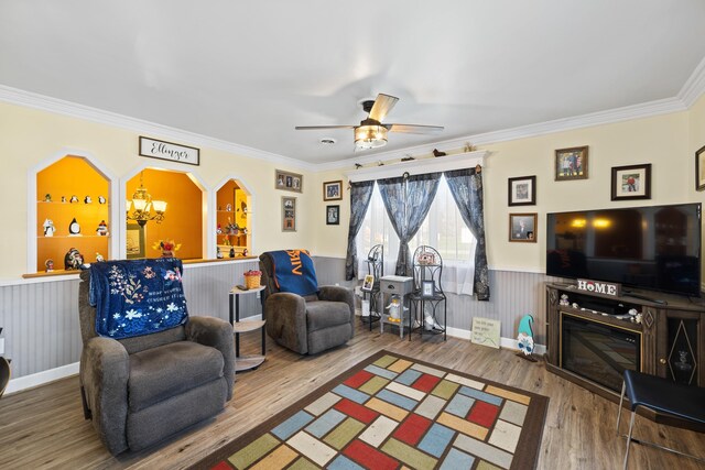 1751 New Hope And Crimora Rd, Crimora, VA 24431 - living room with wainscoting, ornamental molding, ceiling fan with notable chandelier, and wood finished floors