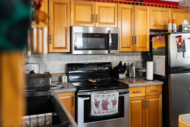 1751 New Hope And Crimora Rd, Crimora, VA 24431 - kitchen with appliances with stainless steel finishes, tasteful backsplash, and brown cabinetry