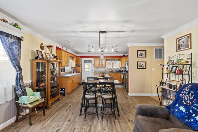 1751 New Hope And Crimora Rd, Crimora, VA 24431 - dining space featuring baseboards, crown molding, visible vents, and light wood-style floors