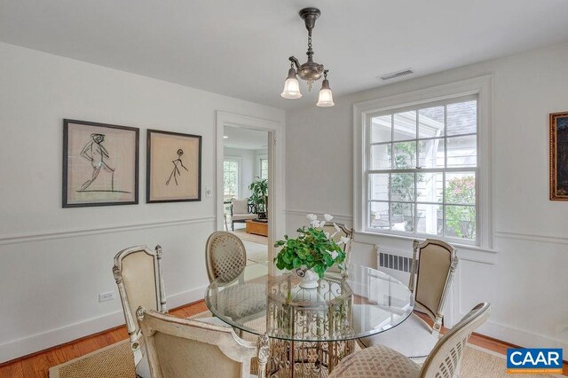 dining space featuring wood finished floors and baseboards