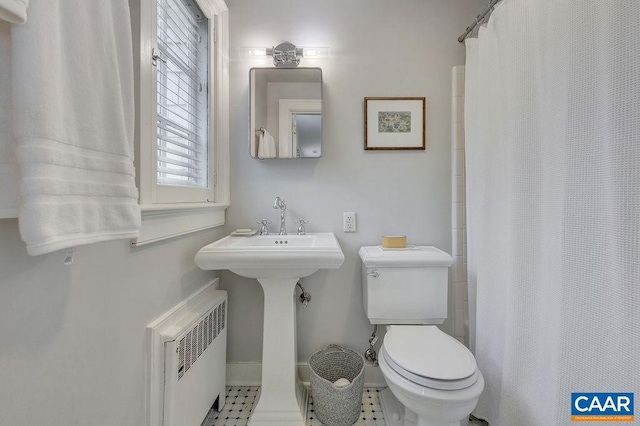 full bathroom featuring radiator heating unit, toilet, curtained shower, and baseboards