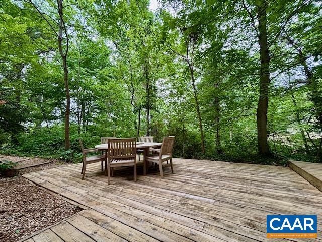 wooden deck featuring outdoor dining area