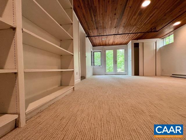 unfurnished living room featuring wood ceiling, plenty of natural light, carpet, and recessed lighting