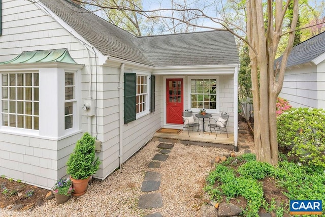 property entrance with a shingled roof