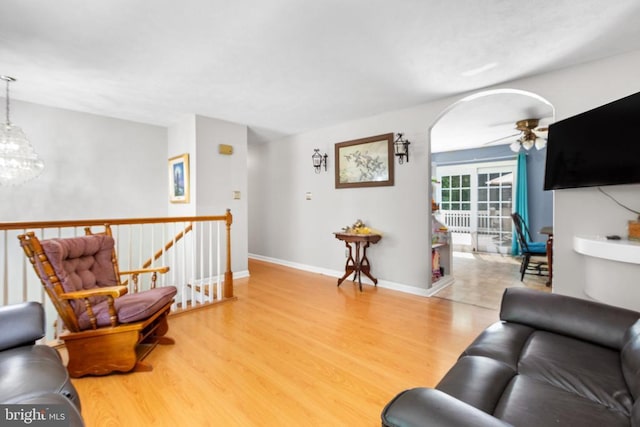 11428 Orange Plank Rd, Locust Grove, VA 22508 - living area featuring wood finished floors, ceiling fan, arched walkways, and a chandelier