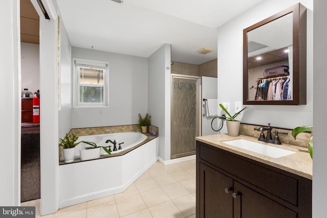 11428 Orange Plank Rd, Locust Grove, VA 22508 - full bath featuring vanity, a shower stall, a garden tub, a spacious closet, and tile patterned flooring
