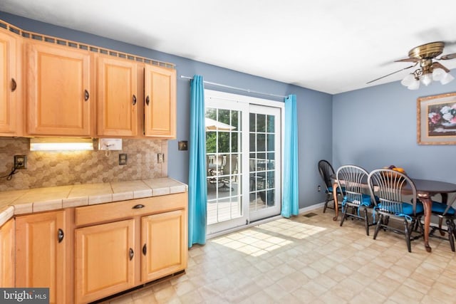 11428 Orange Plank Rd, Locust Grove, VA 22508 - kitchen with light brown cabinetry, light floors, a ceiling fan, and tasteful backsplash