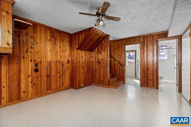 492 Avon Rd, Afton, VA 22920 - additional living space featuring a textured ceiling, stairway, wood walls, and ceiling fan