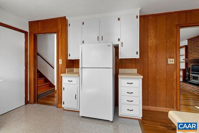 492 Avon Rd, Afton, VA 22920 - kitchen featuring freestanding refrigerator, light countertops, wooden walls, and white cabinets
