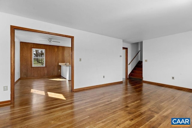 492 Avon Rd, Afton, VA 22920 - unfurnished living room featuring wood finished floors, stairway, baseboards, and wooden walls