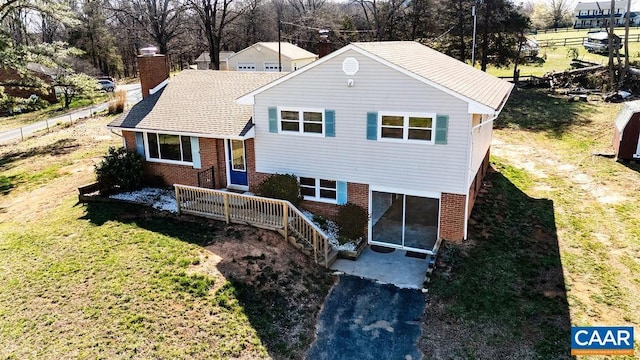 492 Avon Rd, Afton, VA 22920 - tri-level home featuring a chimney, a front yard, and brick siding