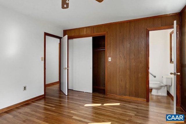 492 Avon Rd, Afton, VA 22920 - unfurnished bedroom featuring wood finished floors, a closet, wood walls, ensuite bathroom, and baseboards
