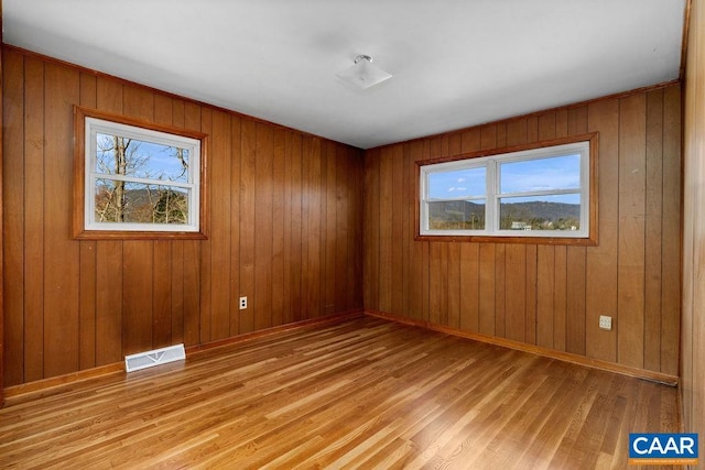 492 Avon Rd, Afton, VA 22920 - unfurnished room with light wood-type flooring, wood walls, and visible vents