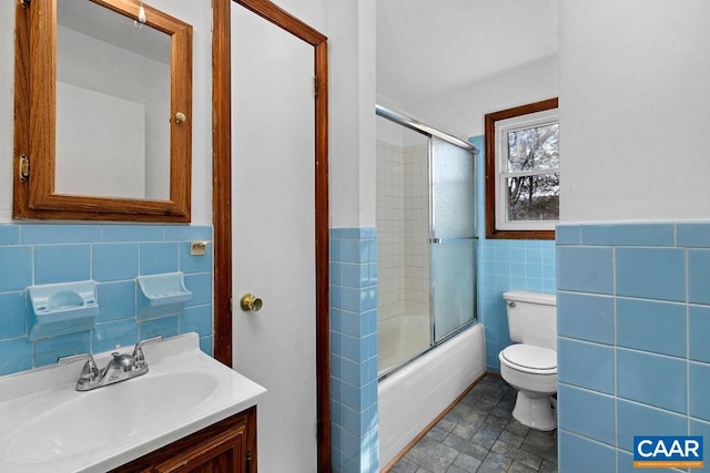 492 Avon Rd, Afton, VA 22920 - bathroom with tile walls, toilet, a wainscoted wall, vanity, and combined bath / shower with glass door