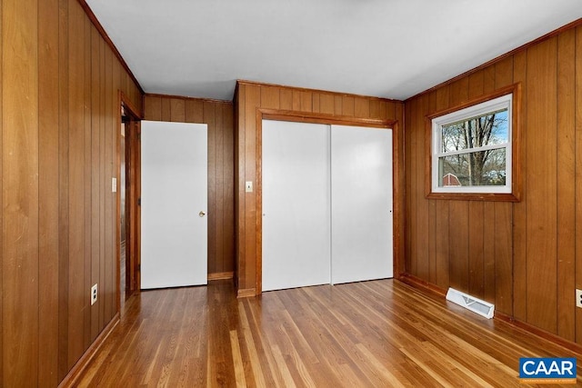 492 Avon Rd, Afton, VA 22920 - unfurnished bedroom featuring wood walls, a closet, visible vents, and wood finished floors