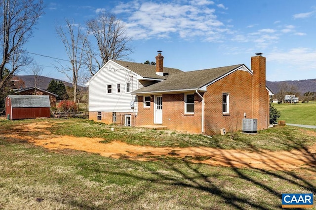 492 Avon Rd, Afton, VA 22920 - rear view of property featuring a chimney, a lawn, brick siding, a shed, and central AC
