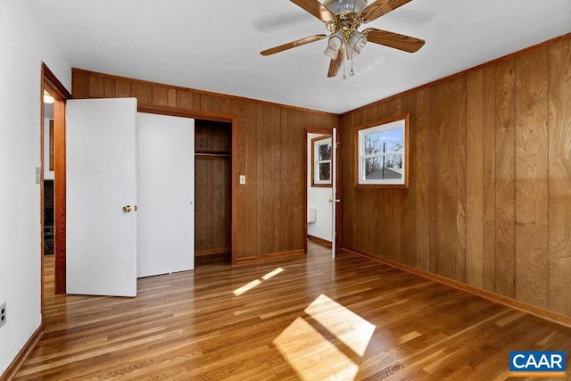 492 Avon Rd, Afton, VA 22920 - unfurnished bedroom with a ceiling fan, a closet, baseboards, wood walls, and wood finished floors