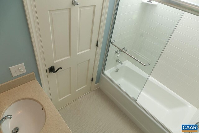 bathroom with a sink and shower / bath combination with glass door
